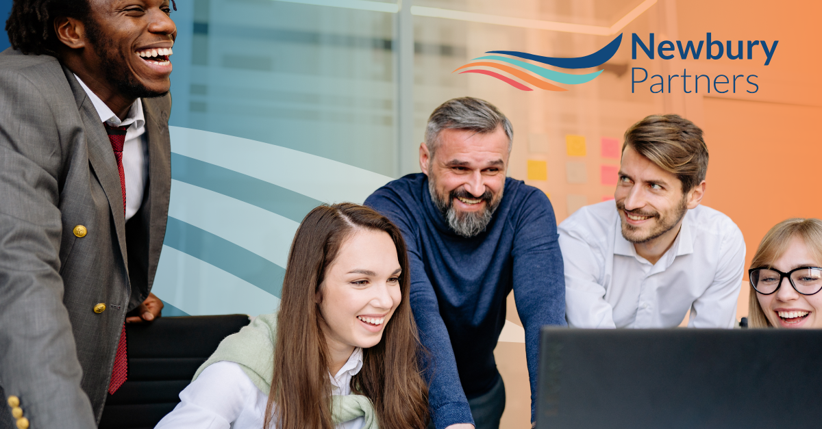 A group of people looking at a laptop.