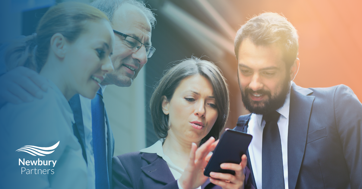A man and woman looking at a cell phone.