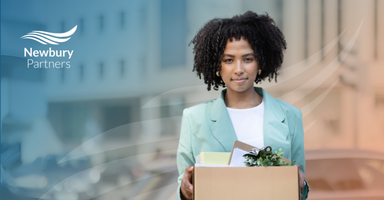 A woman holds a box symbolizing the focus on improving recruiter retention in staffing.