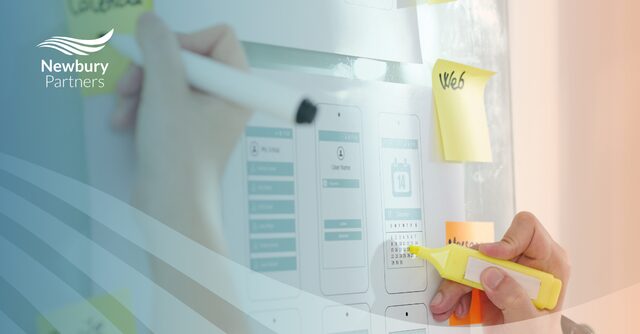 Hand organizing sticky notes on Kanban board demonstrating staffing workflow management with new Kanban release update features.