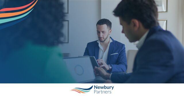 Staffing professionals reviewing CRM system on laptop to improve staffing CRM adoption in their firm.